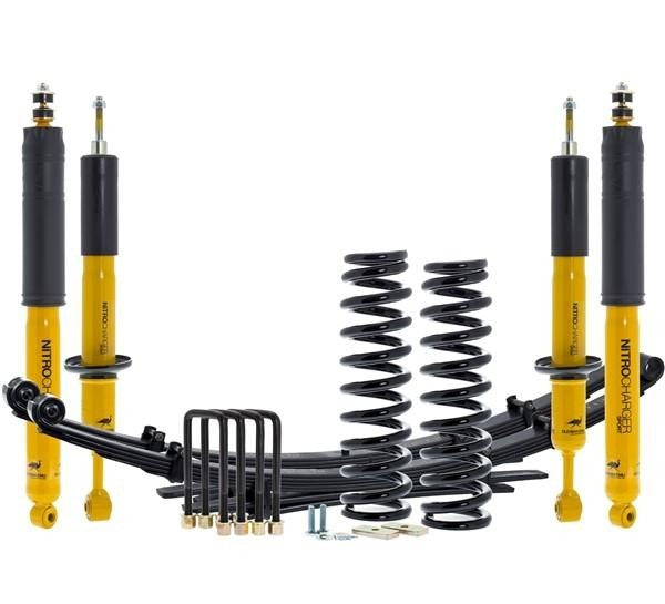 Complete suspension kit with yellow shocks, black coil springs, leaf springs, and mounting hardware for 2016+ Tacoma.