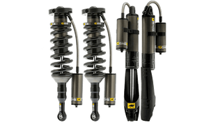 Four black and gray off-road coilover shocks with external reservoirs for 2010 4Runner suspension upgrade.