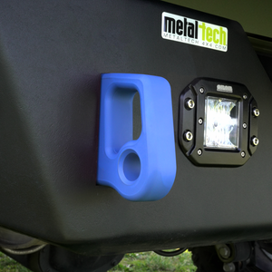 Close-up of blue aluminum rear bumper pull point with Cerakote finish installed next to a black off-road light.