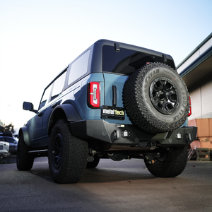 Rear view of blue Bronco 6G with Metal Tech 4x4 high rear bumper and spare tire mounted.