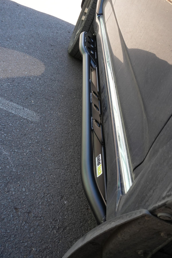 Close-up of black Metal Tech 4x4 rock slider installed on side of 2010-2013 Toyota 4Runner SR5 or Limited.