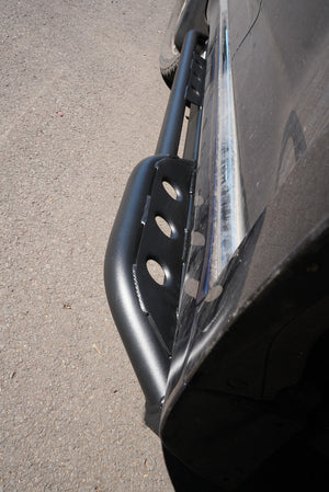 Close-up of black Metal Tech 4x4 rock slider installed on 2010-2013 Toyota 4Runner side step area.