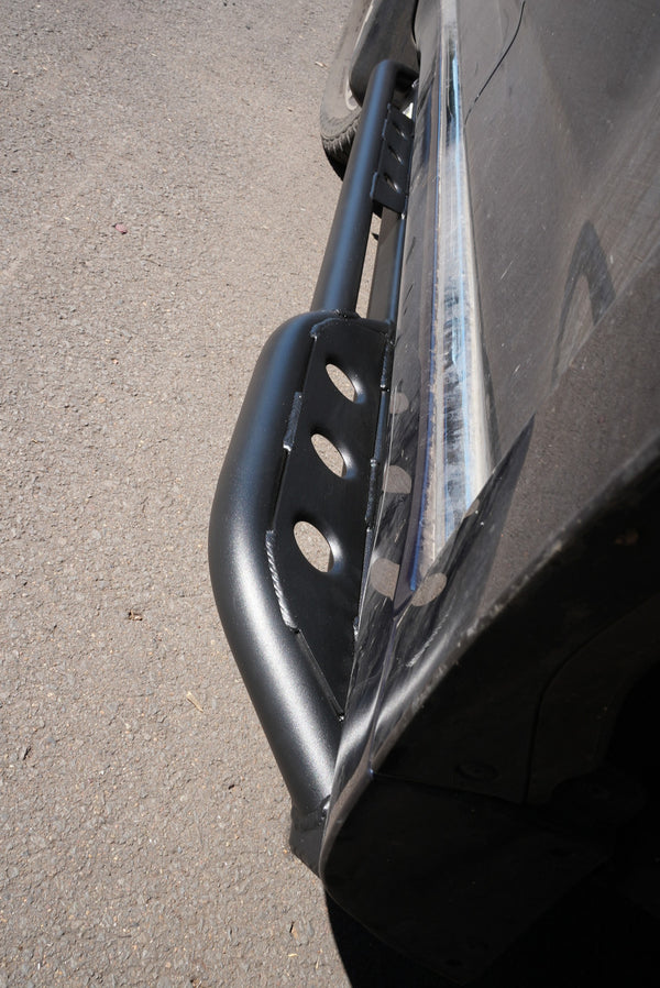 Close-up of black Metal Tech 4x4 rock slider installed on 2010-2013 Toyota 4Runner side step area.