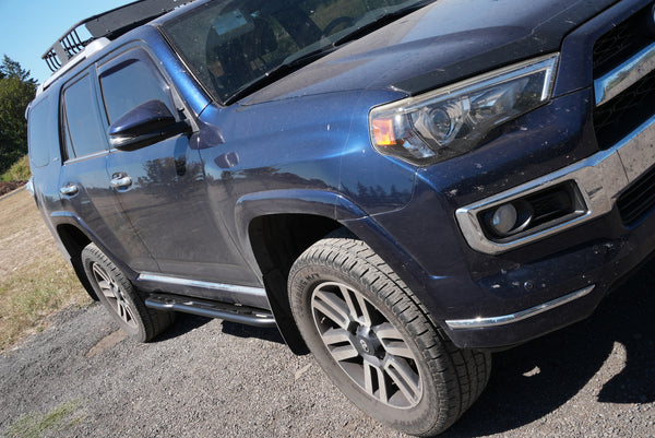 Blue 2010-2013 Toyota 4Runner with Metal Tech 4x4 black rock sliders installed on the driver's side.
