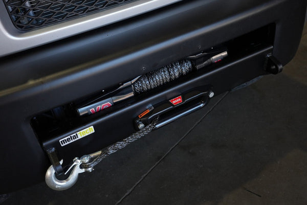 Close-up of Metal Tech Stronghold winch bumper with synthetic rope and metal hook installed on FJ Cruiser front end.