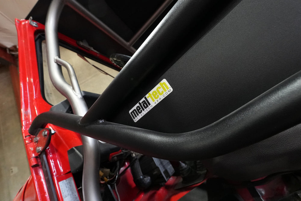 Close-up of black Metal Tech tube door installed on red FJ45 Land Cruiser interior.