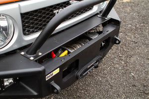 Close-up of black Metal Tech Phantom front bumper with winch installed on silver Toyota FJ Cruiser.