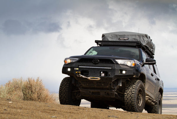 Front view of 5th Gen 4Runner with Metal Tech Fortress front bumper installed, off-road setting with roof tent.