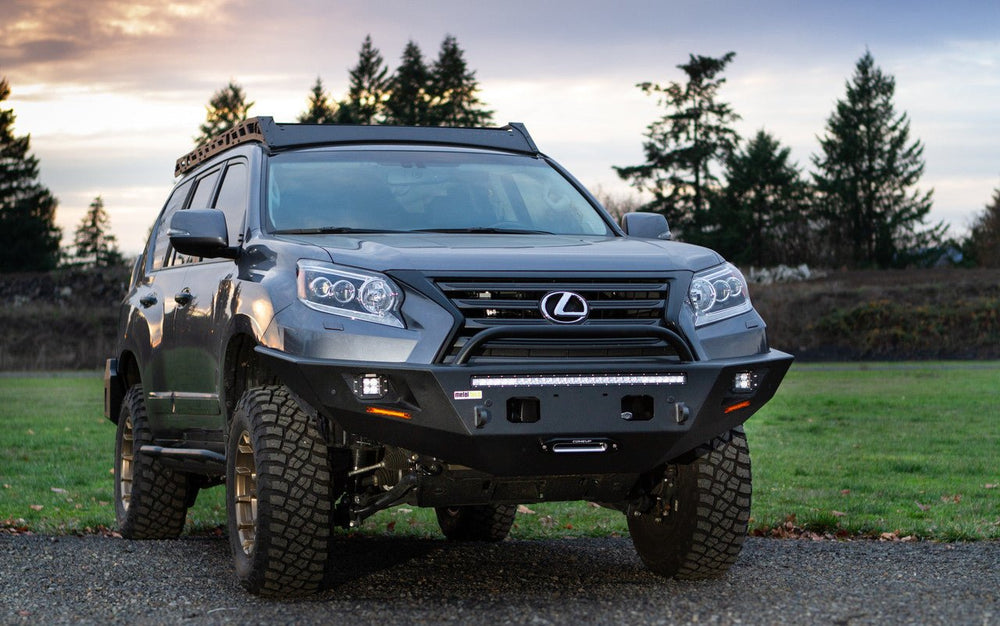Front view of 2014-2023 Lexus GX460 with Metal Tech Tiger Shark steel front bumper installed on gravel.