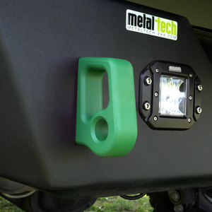 Green aluminum rear bumper pull point with Cerakote finish installed next to a black off-road light on a vehicle.