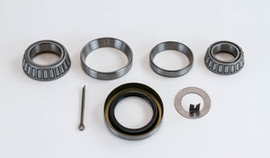 Replacement swing out arm bearing service kit with tapered bearings, seals, and metal washers laid out on white background.