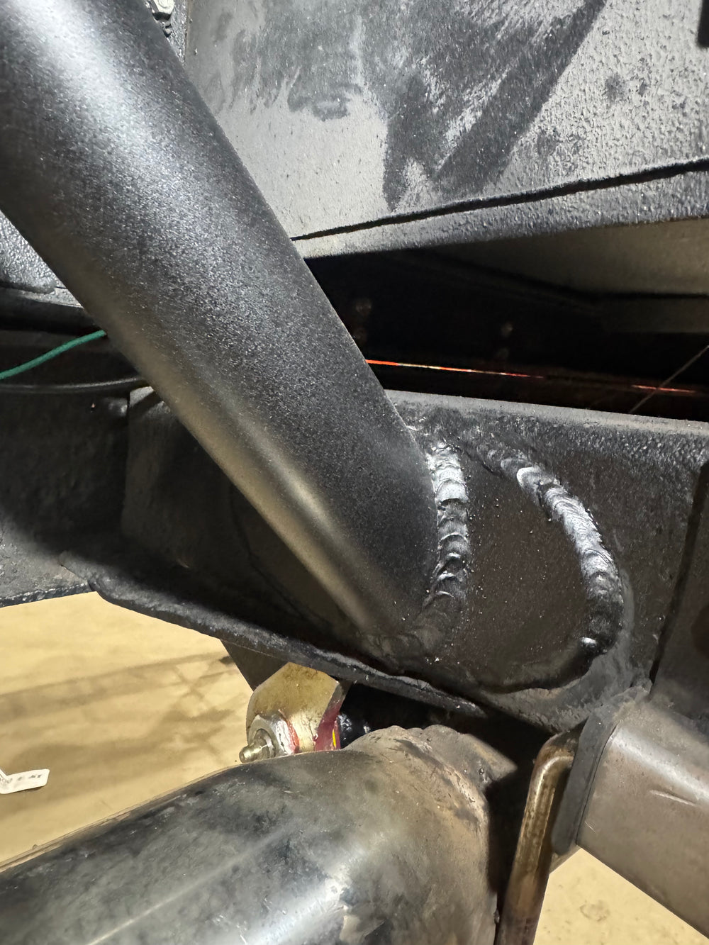 Metal Tech FJ40 Land Cruiser rear roll cage frame tie kit parts laid out on a brown surface.
