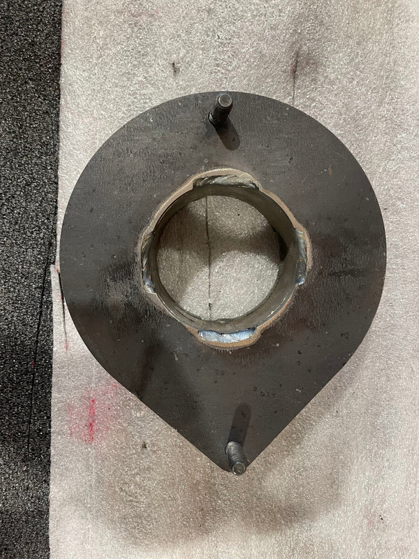 Top view of a scratched and dented metal front spacer plate with two studs, no hardware included.