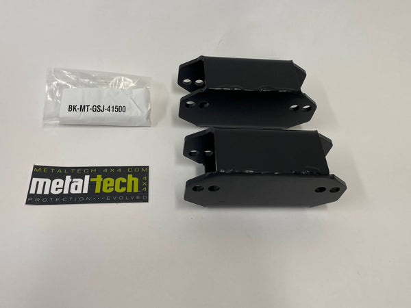 Two black steel rear bump stop extensions with mounting holes, a hardware pack, and a Metal Tech 4x4 logo sticker on a white background.