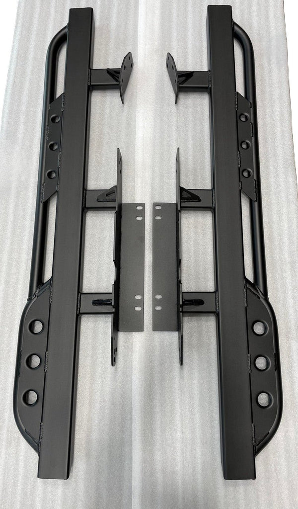 Pair of black metal rock sliders with mounting brackets for 2008-2021 Toyota Land Cruiser, laid flat on white surface.
