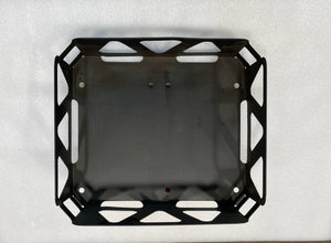 Top view of a black metal utility basket with cutout handles and geometric side patterns.