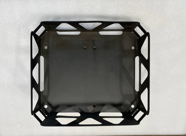 Top view of a black metal utility basket with cutout handles and geometric side patterns.