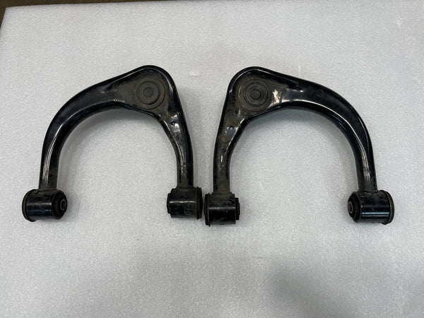 Pair of black upper control arms for GX470, GX460, FJ Cruiser, and 4th-5th gen 4Runner on white background.
