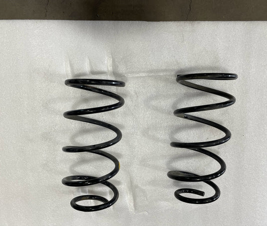 Pair of black rear coil springs for GX470, GX460, FJ Cruiser, and 4Runner on white background.