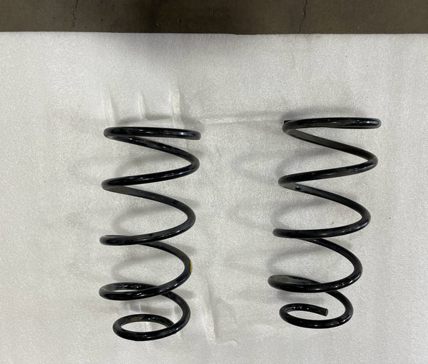 Pair of black rear coil springs for GX470, GX460, FJ Cruiser, and 4Runner on white background.