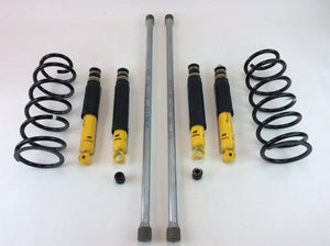 OME 100 Series Land Cruiser suspension kit with coil springs, shock absorbers, and hardware laid out on white background.