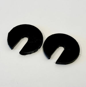 Two black 1/4-inch thick circular body mount shims with a slot cut out, shown on a white background.