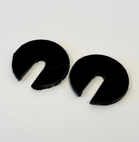 Two black 1/4-inch thick circular body mount shims with a slot cut out, shown on a white background.