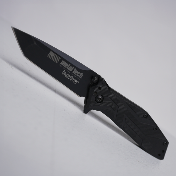 Black Metal-Tech 4x4 custom Kershaw folding knife with textured handle and partially serrated blade.