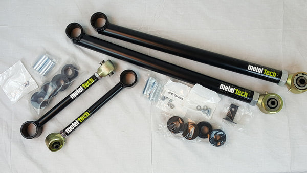 Metal Tech 4x4 rear upper and lower suspension links with hardware for FJ Cruiser and 4Runner, laid out on white surface.