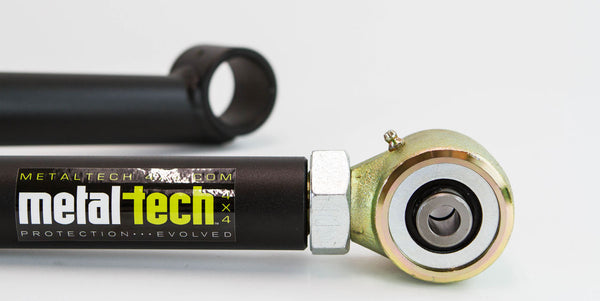 Close-up of Metal Tech 3rd Gen 4Runner rear lower link with black tube and gold-toned rod end bearing.
