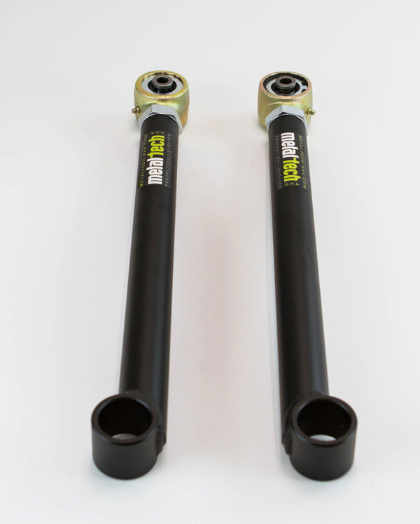 Pair of black Metal Tech rear lower links for 3rd Gen 4Runner with gold-toned rod ends on white background.