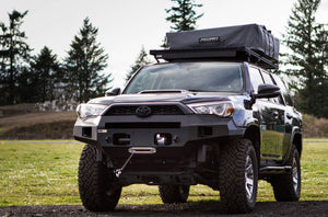 Front view of 5th Gen 4Runner with Metal Tech Fortress steel bumper and roof rack tent in outdoor setting.