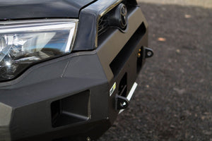 Close-up of black Metal Tech Fortress front bumper installed on 2014-2019 5th Gen Toyota 4Runner showing headlight and tow hooks.