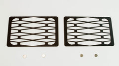 Pair of black metal tech winch hole covers with geometric cutouts for Fortress bumper, shown flat on white background.