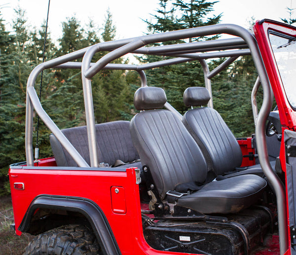 Full side view of red FJ40 Land Cruiser with installed metal roll cage and black front bucket seats.