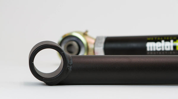 Close-up of black adjustable rear upper and lower suspension links for 80 Series Land Cruiser LX450.