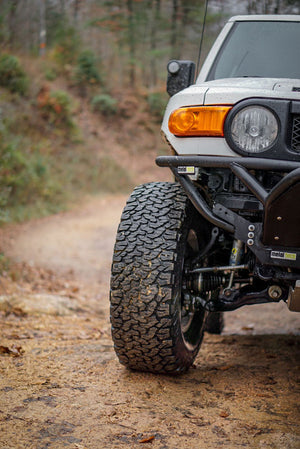 Close-up of Metal Tech front tube bumper installed on white FJ Cruiser off-road vehicle.