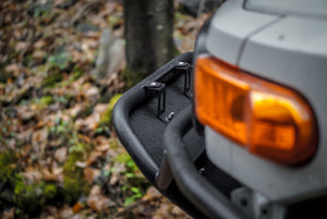 Close-up of black Metal Tech front tube bumper installed on gray FJ Cruiser with amber turn signal visible.