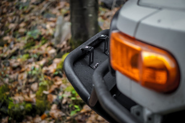 Close-up of black Metal Tech front tube bumper installed on gray FJ Cruiser with amber turn signal visible.