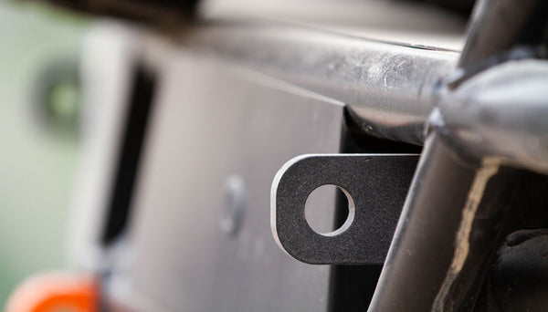 Close-up of metal mounting bracket on the Metal Tech FJ Cruiser rear tube bumper showing weld and bolt hole.