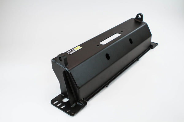 Black metal winch bumper for FJ Cruiser with mounting holes and welded reinforcements, angled view on white background.