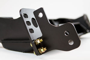 Close-up of black metal bracket with mounting holes and gold bolts on FJ Cruiser Stronghold winch bumper.