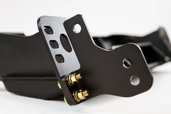 Close-up of black metal bracket with mounting holes and gold bolts on FJ Cruiser Stronghold winch bumper.
