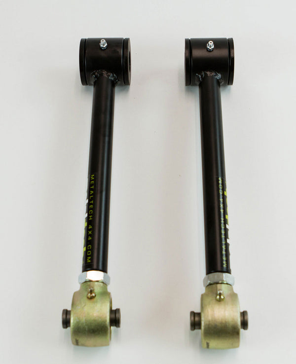Pair of black metal rear upper suspension links for FJ Cruiser and 4Runner with gold-colored mounting ends on white background.
