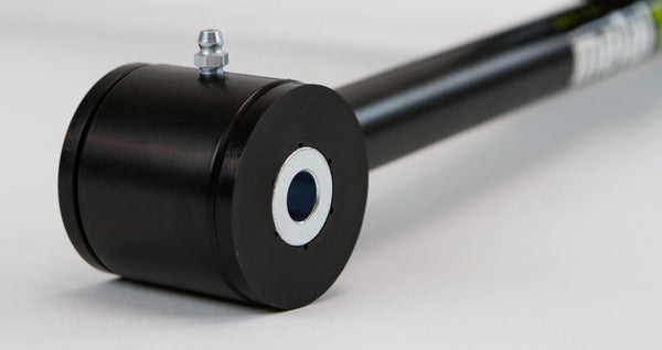 Close-up of black metal rear upper link with bushing and grease fitting for FJ Cruiser and 4Runner suspension.