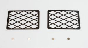 Two black metal winch hole covers with diamond pattern and four small round magnets on white background.