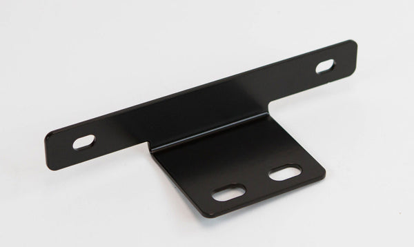 Black metal rear license plate holder add-on with multiple mounting slots, angled for easy installation.