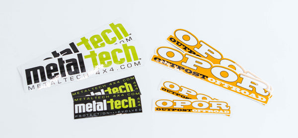 Set of Metal Tech and OPOR Outpost Offroad stickers in black, white, green, and orange colors on a white background.