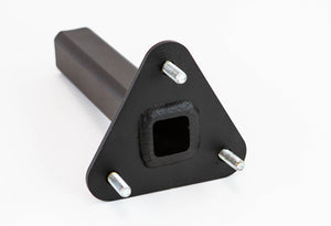 Close-up of black metal rear bumper tire carrier stinger mount with triangular base and three bolts.