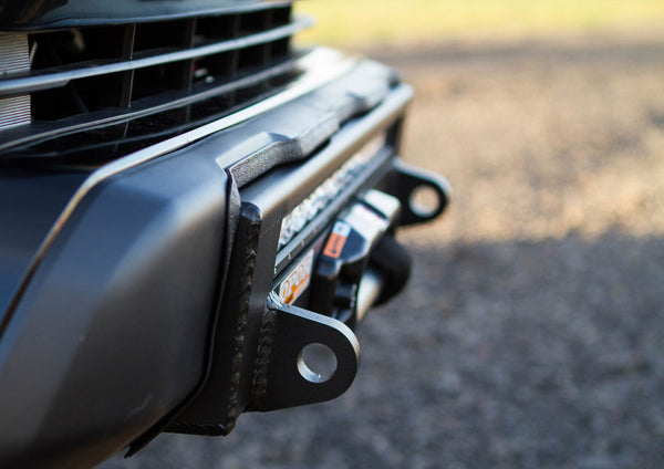 Close-up of the black steel Stronghold winch bumper installed on a 2016 Tacoma front end.